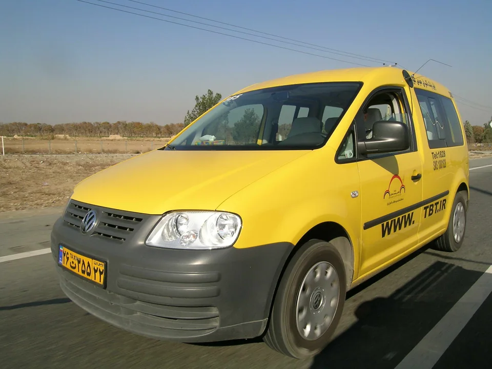 A yellow Volkswagen Caddy bearing TBT branding and 1828 in the company archive