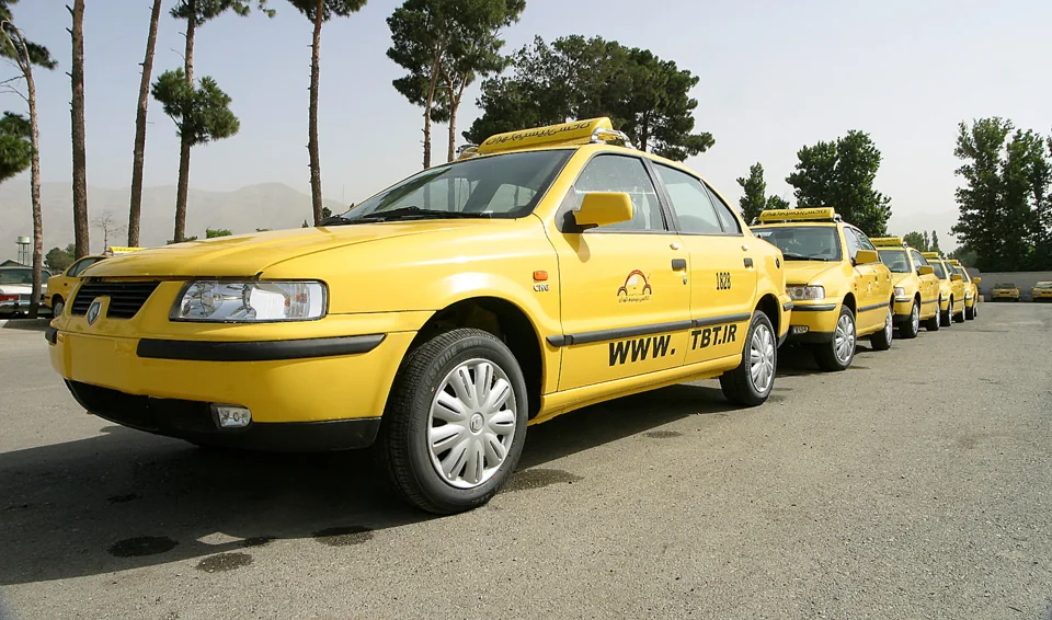 A line of yellow Samand taxis bearing Taxi Bisim Tehran branding in the company archive